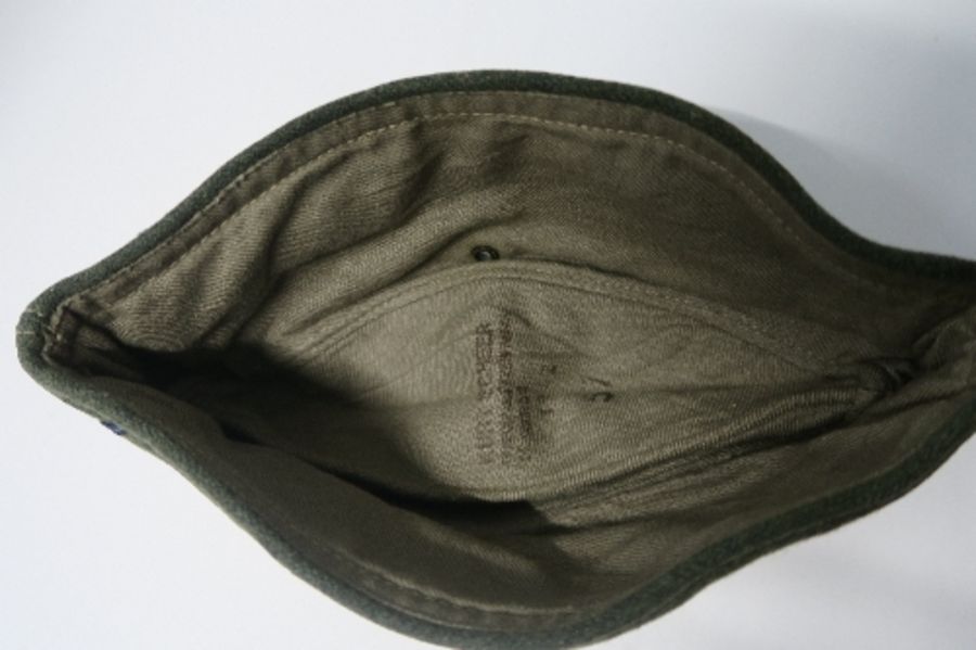 A Third Reich style M38 side hat, in grey wool fabric, having appliqued white RMBO motif to the - Image 9 of 19