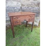 An 18th century oak low boy, fitted with one long drawer and two short drawers within a shaped