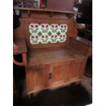 An Arts and Crafts style tile backed wash stand, with cupboard door below, width 41.5ins x height