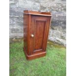 A Victorian mahogany tray top pot cupboard, fitted with a panel door, opening to reveal shelves,