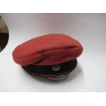 An Imperial German army style beret, in red wool with red piped black headband, Imperial style metal