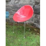 Red plastic and Perspex chair raised on metal legs
