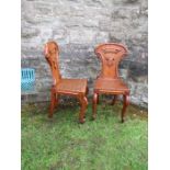 Two pairs of armorial hall chairs, in oak
