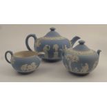A 19th century Wedgwood blue Jasper ware three piece tea set, decorated with figures and trees