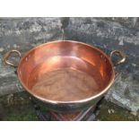 A large copper two handled jam pan, diameter 19.5ins
