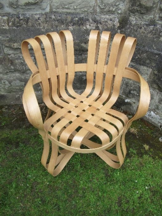 An armchair of cross check in bent and laminated wood after Frank Gehry