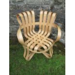 An armchair of cross check in bent and laminated wood after Frank Gehry
