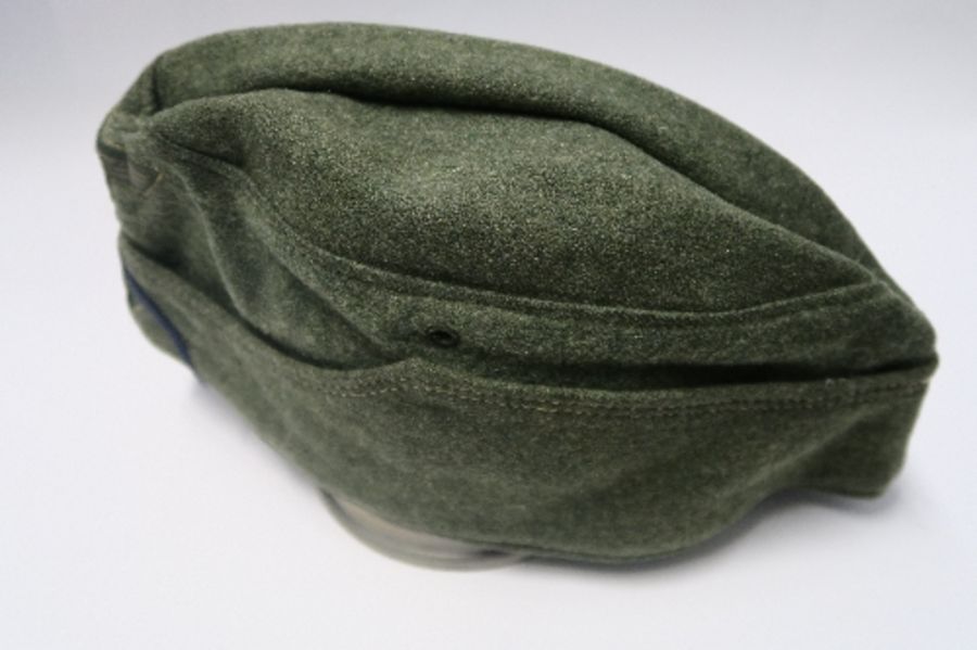 A Third Reich style M38 side hat, in grey wool fabric, having appliqued white RMBO motif to the - Image 6 of 19