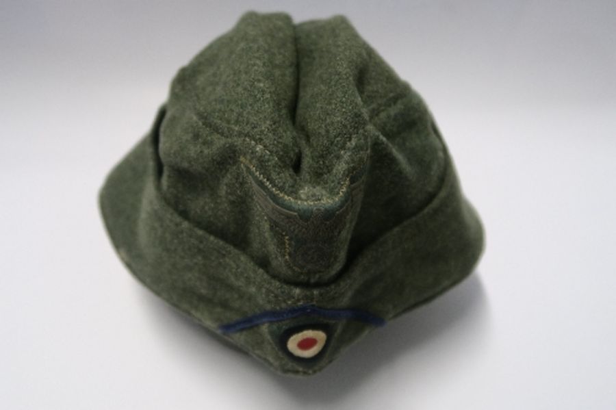 A Third Reich style M38 side hat, in grey wool fabric, having appliqued white RMBO motif to the - Image 5 of 19