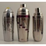 Three silver plated cocktail shakers, two with ingredients for different cocktails