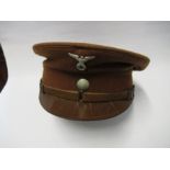 A Third Reich style, brown wool visor cap, with white metal RMBO badge to the front, above a