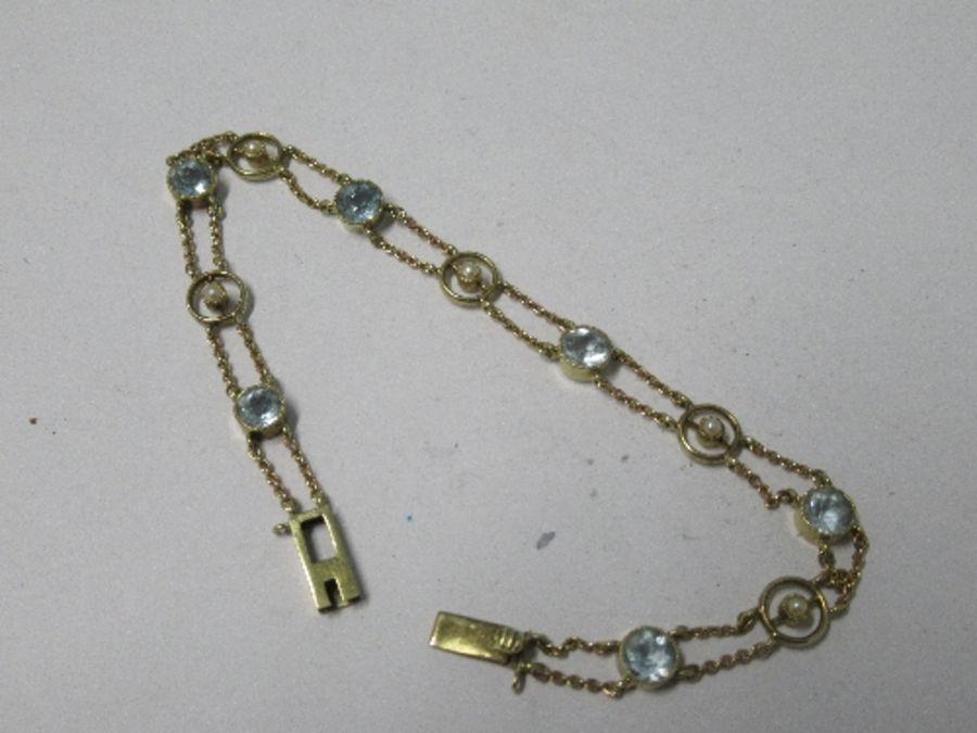 An Edwardian aquamarine and seed pearl bracelet, the six round cut aquamarines alternate set with