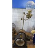 A brass oil lamp, with telescopic stand, having a glass shade, converted to electricity, together