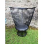 Ebonised high comb back chair of inverted pyramid form.