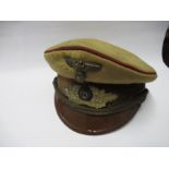 A Third Reich style Gauleiter's visor cap, in brown cotton with red piping, with brown velvet hat