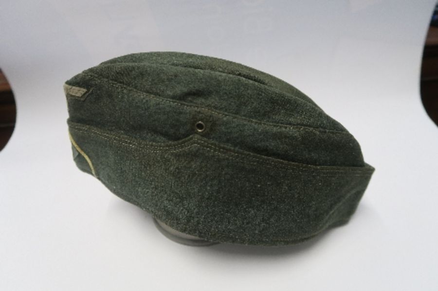 A Third Reich style M38 side hat, in grey wool fabric, having appliqued white RMBO motif to the - Image 2 of 19