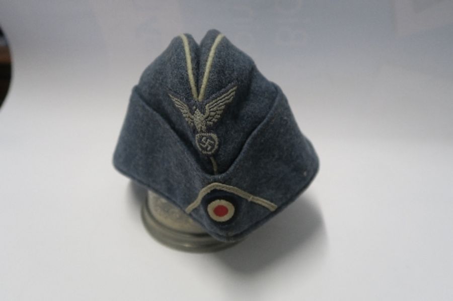 A Third Reich style M38 side hat, in grey wool fabric, having appliqued white RMBO motif to the - Image 11 of 19