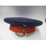 An Imperial German army style hat, in blue wool with red felt style band, the interior stamped 3E