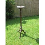 A mahogany torchere, having a reeded column, raised on a tripod base, terminating in claw on ball