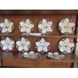 Ten Royal Worcester plates, decorated with a central landscape panel, to a blue border with floral