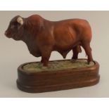 A Royal Worcester model, of a Bull, with wooden plinth base, height 5.25ins