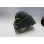 A Third Reich style officer's side hat in green wool, with appliqued yellow RMBO logo to the