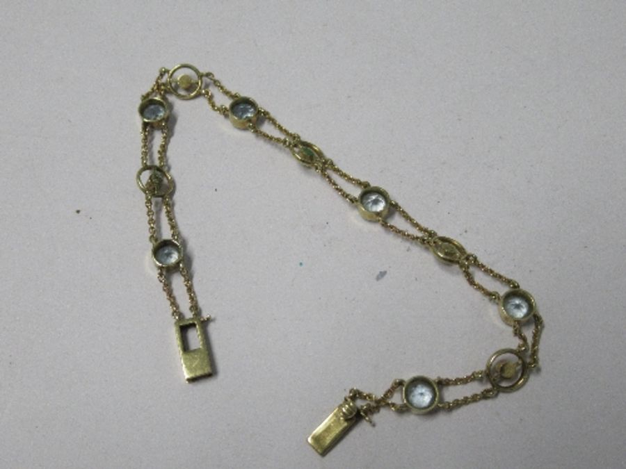 An Edwardian aquamarine and seed pearl bracelet, the six round cut aquamarines alternate set with - Image 2 of 3