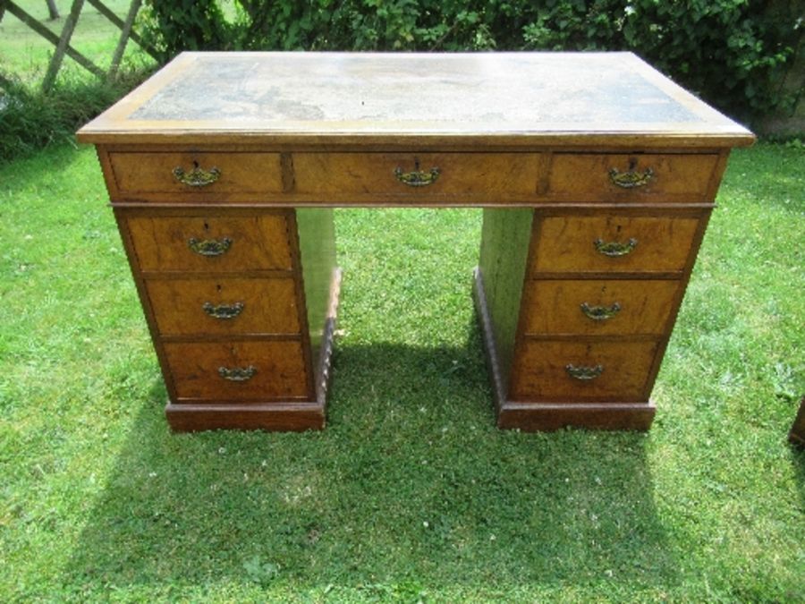 A Victorian oak and burr oak desk, fitted with one long drawer, flanked by four graduated drawers to