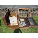 A quantity of various clock and other parts, to include two late 19th century wall clock frames,