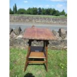 An Arts and Crafts style square topped side table, raised on outswept legs united by a shelf,