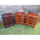 A pair of bow front reproduction mahogany chests, together with a serpentine fronted reproduction