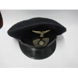 A Third Reich Kriegsmarine style visor cap, in navy blue wool, with black hat band and black leather