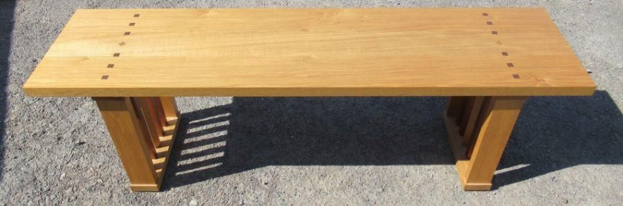 An oak and black walnut bench, with label to the base, Jeremy Cornwell, width 59ins x height 18.5ins