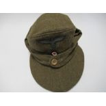 A German Third Reich style M43 single button field cap, in brown wool fabric, bearing appliqued RMBO