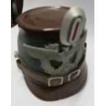 A German Third Reich style police shako helmet, having green wool body, brown patent leather top and