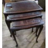 A nest of three oak tables, with glass tops, width 22ins and down