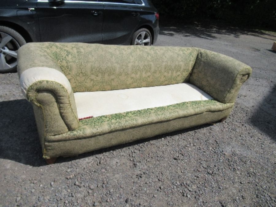 A Chesterfield sofa, with roll ends and raised on short inverted legs, no cushions, width 88ins x