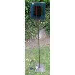 A floor standing lamp, with coloured glass panel