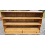 A modern pine bookcase, fitted with two drawers to the base, width 66ins, height 41ins, depth 16ins,