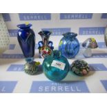 A collection of coloured glass including paperweights