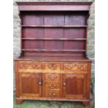 An Antique oak dresser, with plate rack over three drawers, over one central drawer over two dummy ,