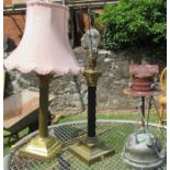 A gilt and black metal Corinthian column table lamp, together with another similar table lamp and
