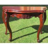 A mahogany serpentine side table, with carved decoration, width 40ins, height 30ins