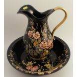 A Bassona wash jug and bowl, decorated with flowers to a black ground, signed