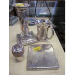 A silver cigarette case, silver candle stick, silver mug with engraved decoration, and hallmarked