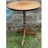 A Victorian occasional table, the circular top raised no a barley twist column to a triform base,