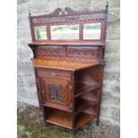 An Edwardian chiffonier / sideboard, having carved and pierced frieze over three mirrors, with