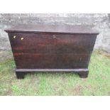 An antique oak coffer, raised on bracket feet, width 42ins x depth 19.5ins x height 29ins