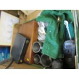 A box to include pewter tankard, flatware, tribal bookends, cased fish knives, etc.