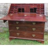 An Antique mahogany bureau, the sloping fall front opening to reveal drawers, pigeon holes and a